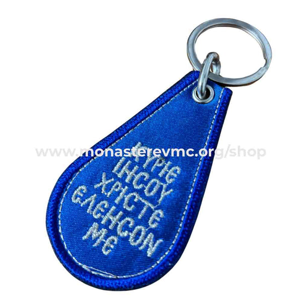 Orthodox key chain imported from Greece. black woven with IC XC NI KA gold embroidery in the front and the prayer to the Theotokos in English on the back. / Porteclé orthodoxe tissé noir avec broderie en or importé de la Grèce vendu par les soeurs du monasterevmc.org