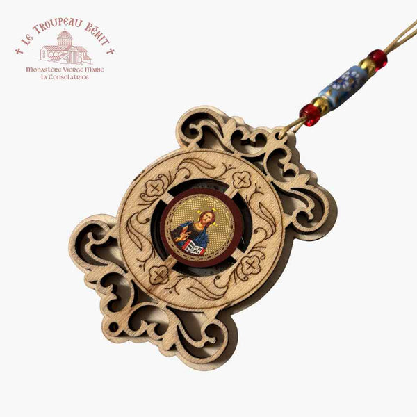 Decorative wooden pendant with religious icon and beaded string on a white background featuring 'Troupeau Benit' logo branding