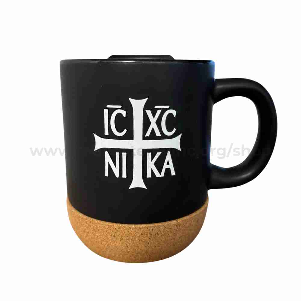 Black mug with cork base featuring a white cross and text on a white background sold by the sisters of monasterevmc.org