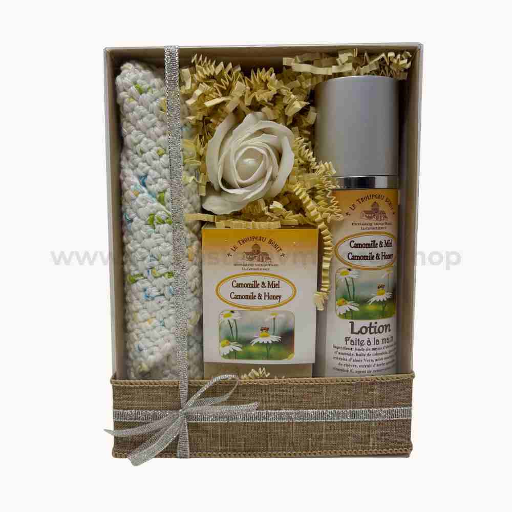 Gift set with a knitted wash cloth, chamomile-honey scented goat milk soap, and lotion in a decorative box.