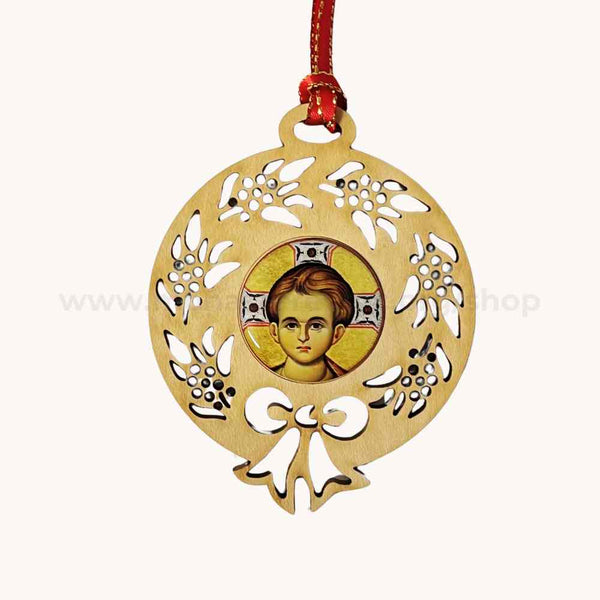 Decorative pendant with a cut-out design of Christ Emmanuel and a central portrait on a white background.
