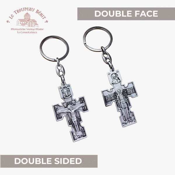 Double-sided cross keychain with 'Le Troupeau Bemil' branding on a light gray background.
