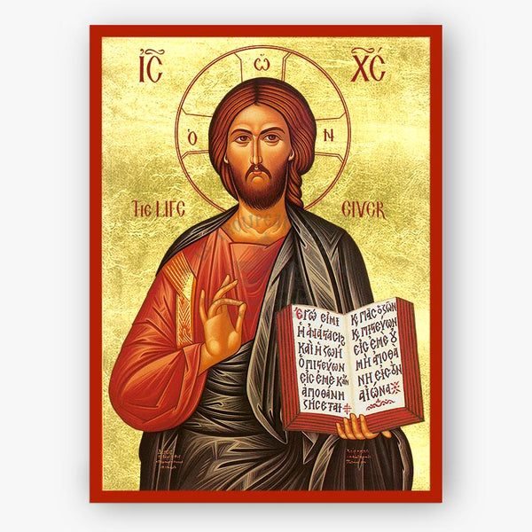 A gold-toned religious icon print of Jesus Christ with a red border, holding an open book and making a blessing gesture. The artwork fills most of the frame against a plain light background.