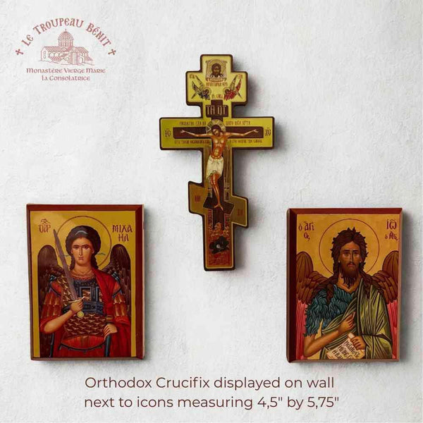 Orthodox Crucifix and icons displayed on a wall with branding 'Troupeau Benit' at the top.