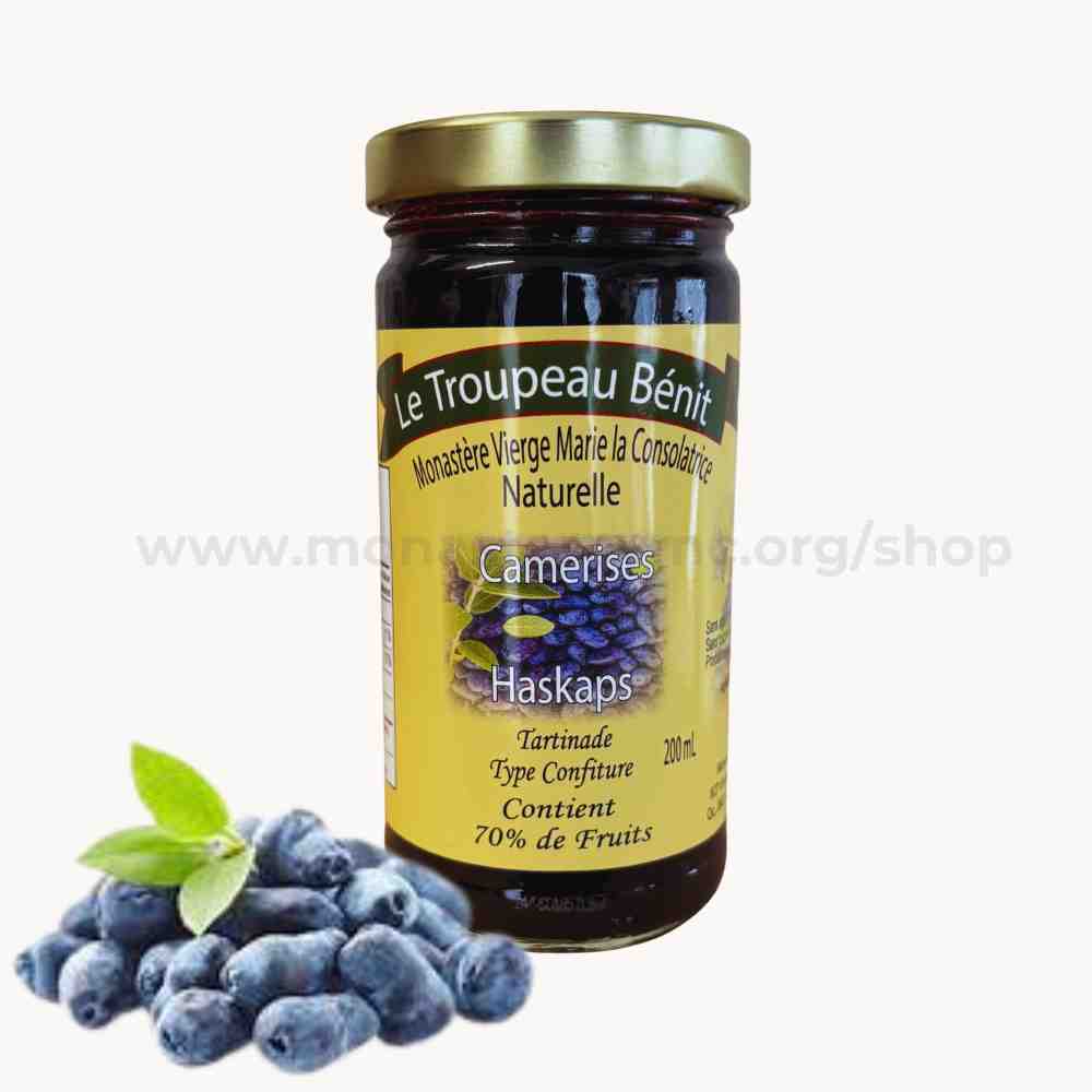 Jar of Le Troupeau Benit jam with haskap berries on a white background
