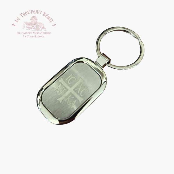Metallic keychain with engraved text on a white background