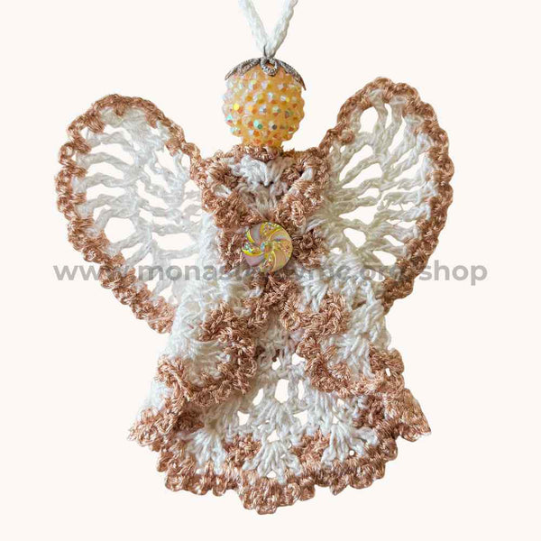 Crocheted angel ornament with metallic pink accents on a white background
