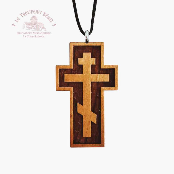 Wooden cross on black cord displayed on white background with 'Troupeau Benit' logo branding