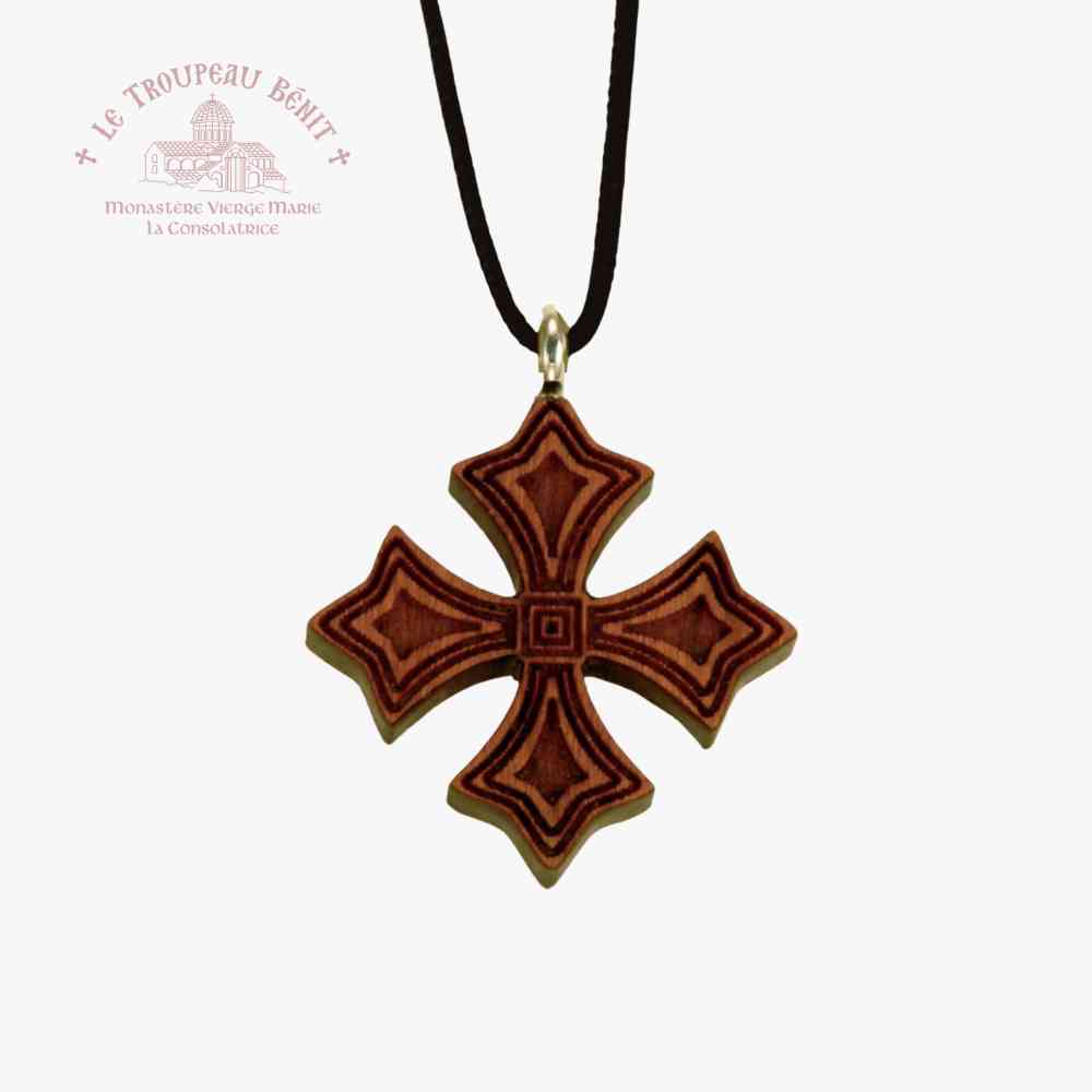 Wooden cross pendant on a black cord with a white background with 'Troupeau Benit' logo branding