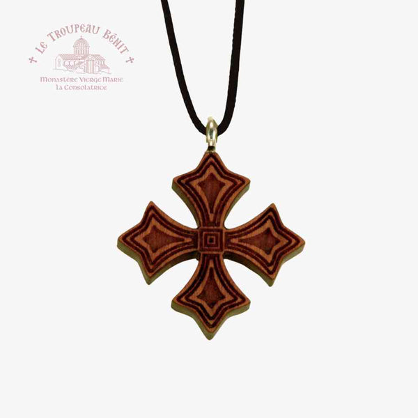 Wooden cross pendant on a black cord with a white background with 'Troupeau Benit' logo branding