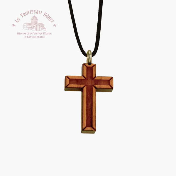Wooden cross pendant on a black cord with a white background with 'Troupeau Benit' logo branding