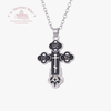 Silver cross pendant necklace on a white background with 'Le Troupeau Bénit' logo.