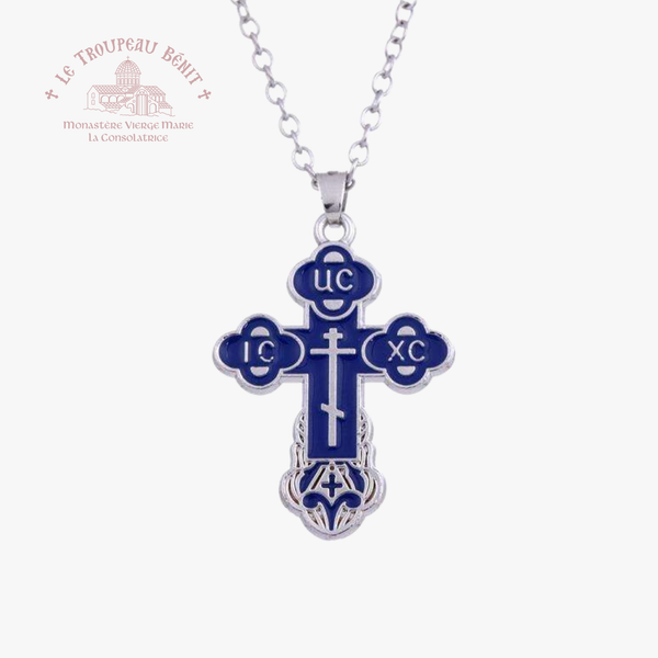 Blue and silver cross pendant on a white background with 'Le Troupeau Bénit' branding.