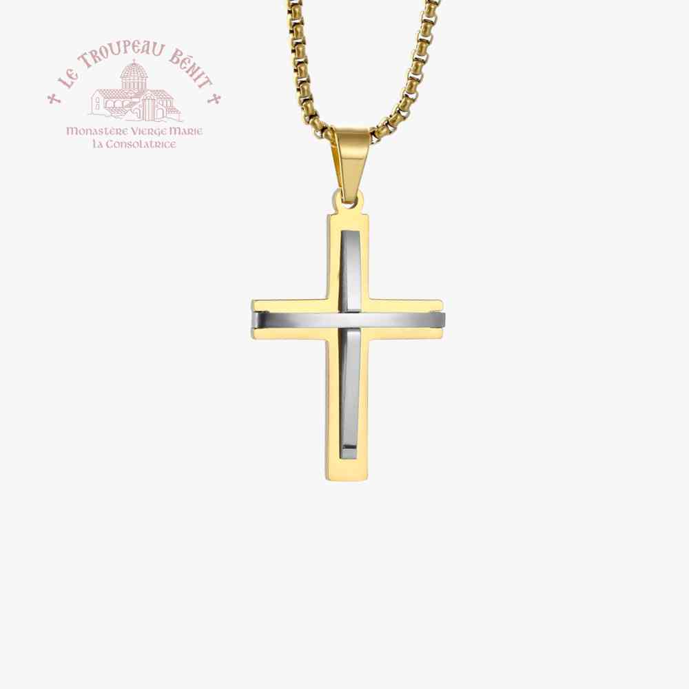 Gold and silver cross pendant on a white background with Le Troupeau Benit logo.