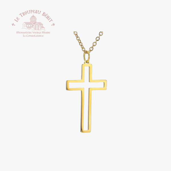 Gold cross necklace on a white background with 'Le Troupeau Bénit' branding.