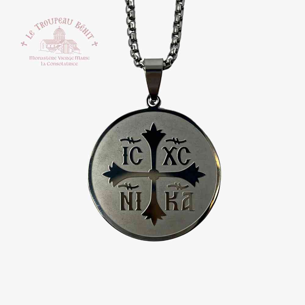 Silver necklace with a round pendant featuring IC XC NI KA and Cross symbols on a white background.