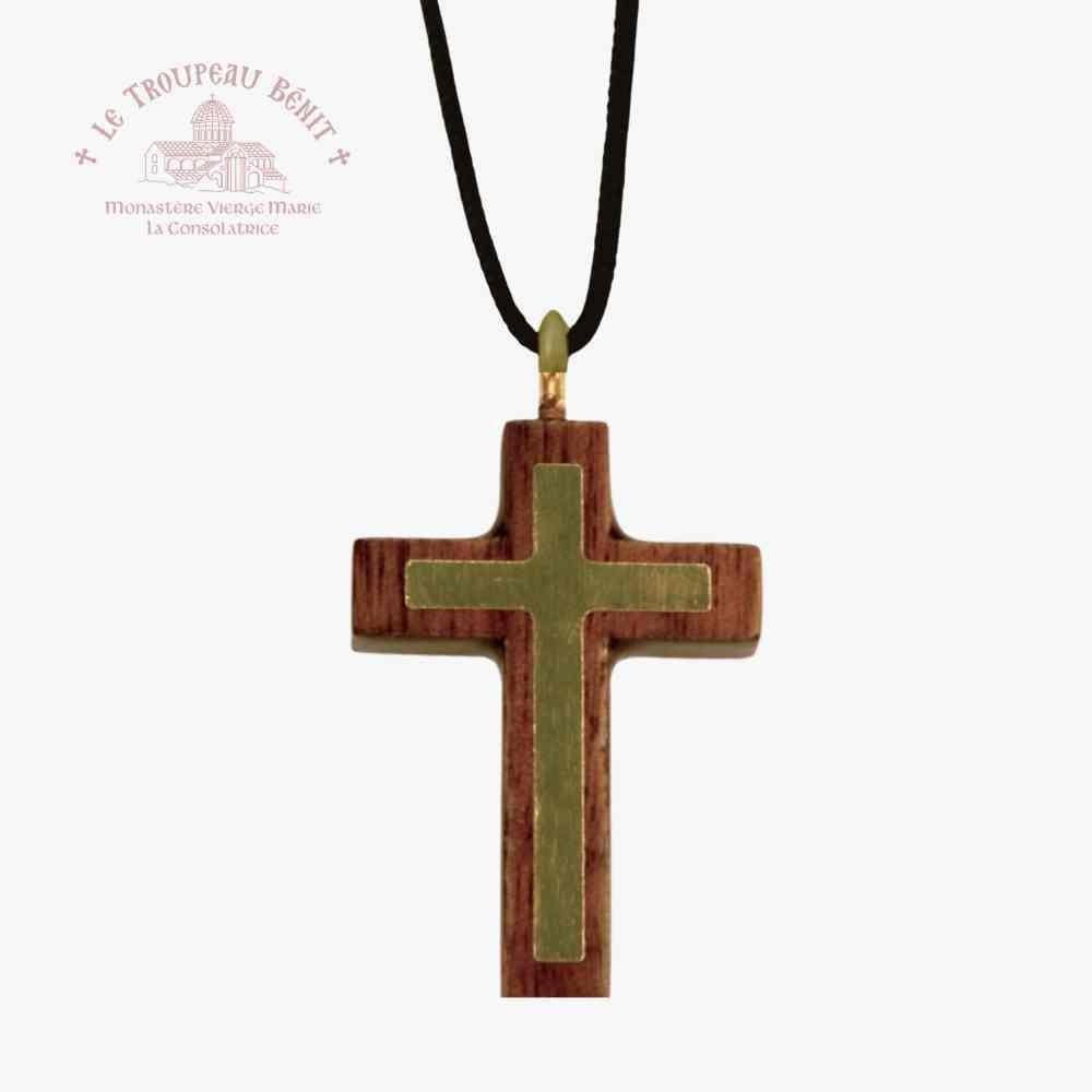 Wooden cross pendant on a black cord with a visible brand logo 'Toupeau Benit' on a white background