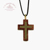 Wooden cross pendant on a black cord with a visible brand logo 'Toupeau Benit' on a white background