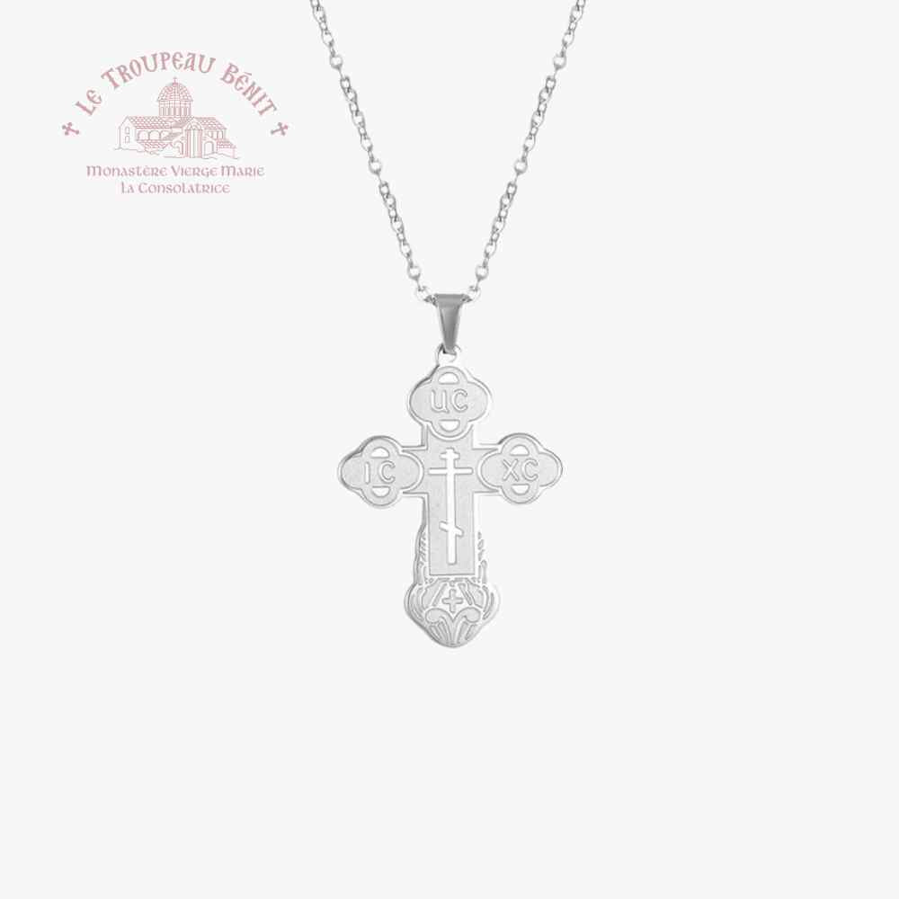 Silver cross pendant necklace on a white background with Troupeau Benit brand logo.