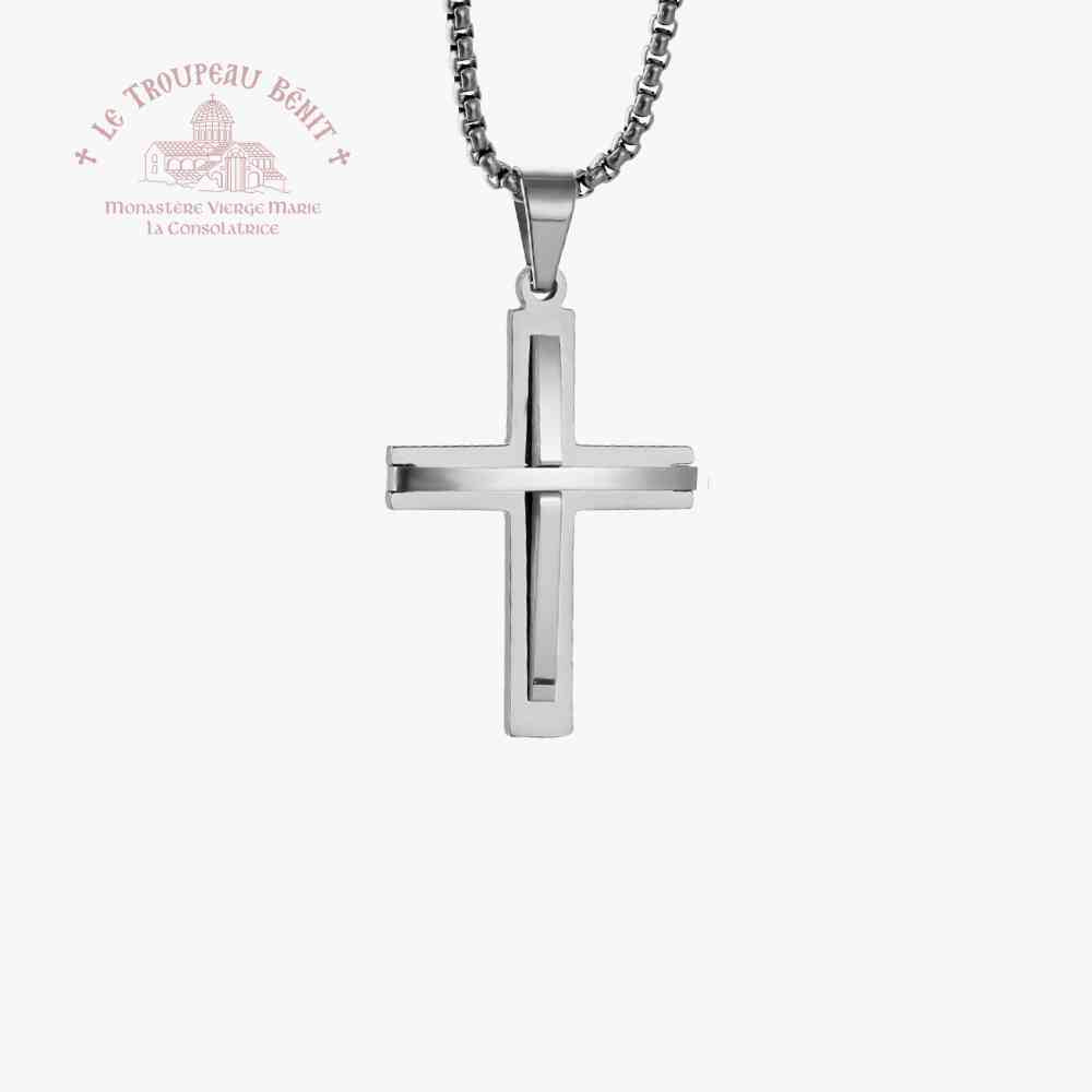 Silver cross pendant on a white background with Le Troupeau Bénét logo.