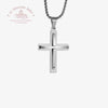 Silver cross pendant on a white background with Le Troupeau Bénét logo.