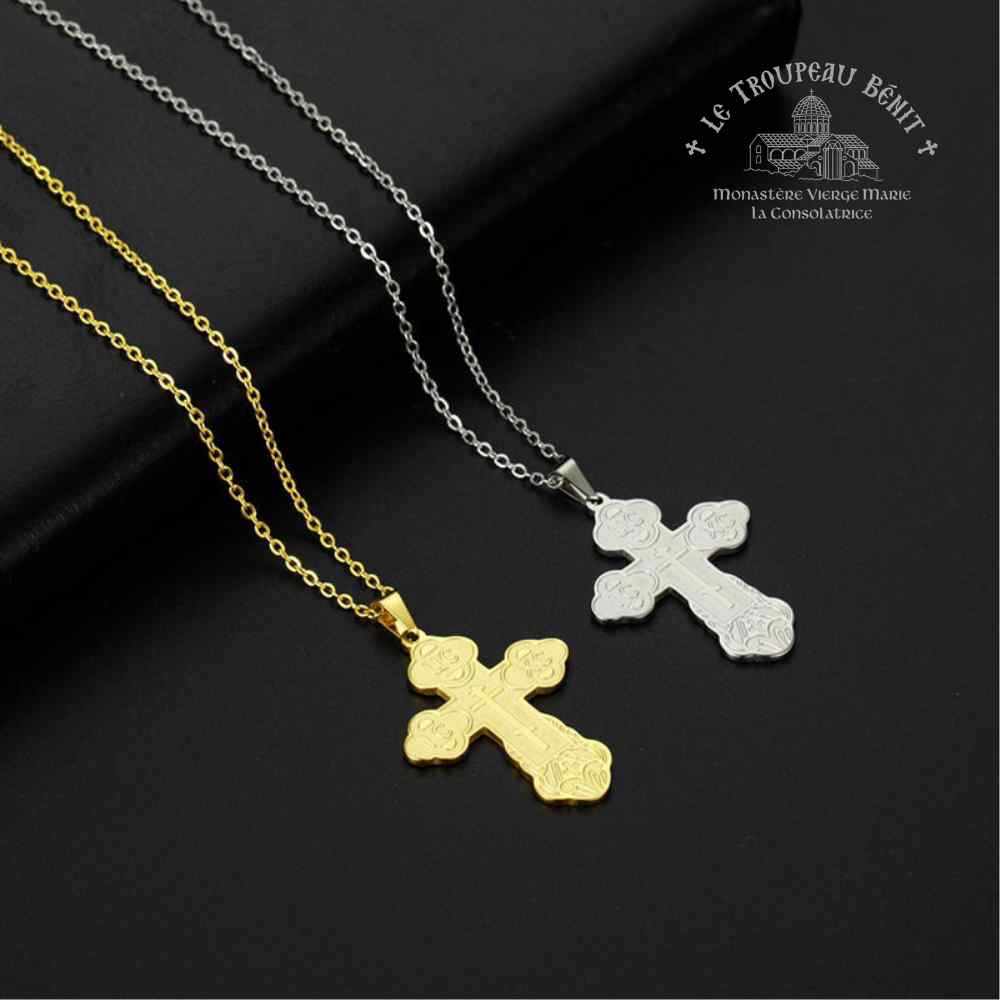 Two cross-shaped pendants on gold and silver chains against a black background with Troupeau Benit brand logo.