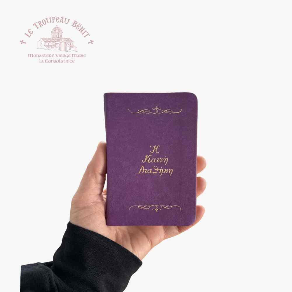 Purple book with gold text on a white background, featuring the logo of Le Troupeau Bénit.