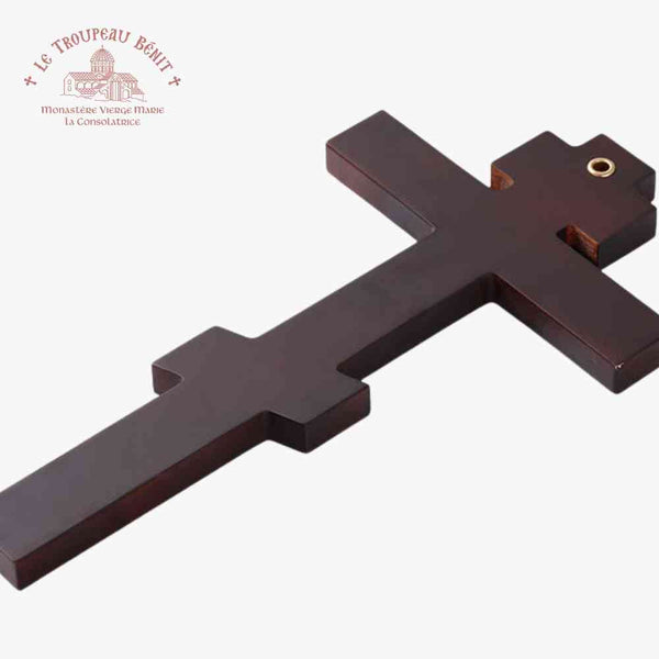 Back of decorative cross with minimalist icon of Christ crucified on a light blue background with Troupeau Benit logo