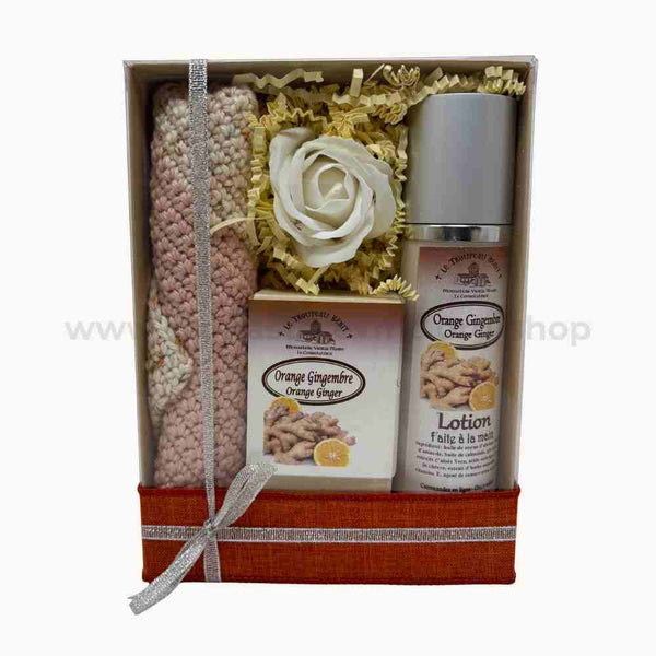 Gift set with a knitted washcloth, orange ginger scented soap, and lotion in a decorative box.