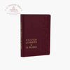 Maroon leather-bound book with gold embossed text on a white background with "Troupeau Benit" logo branding