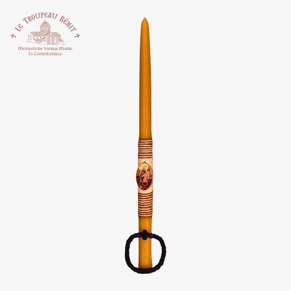 Decorative candle with intricate design on a white background, featuring the Le Troupeau Benit logo.