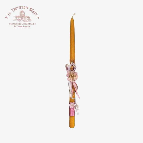 Decorative candle with floral accents on a white background, featuring Le Troupeau Bénit logo.