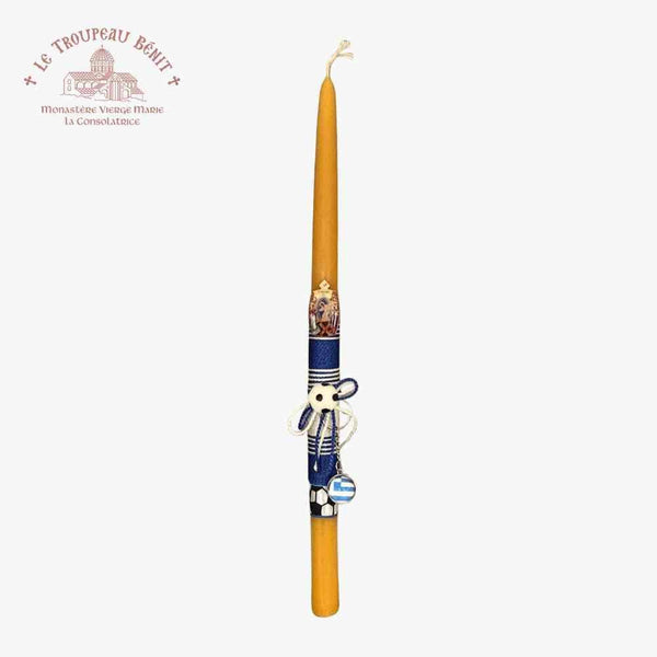 Decorative candle with a blue holder featuring a design on a white background, with 'Le Troupeau Benit' branding.