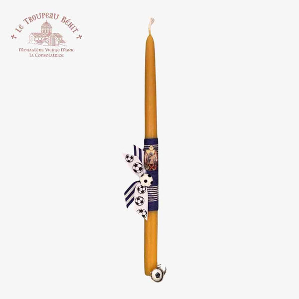 Decorative candle with a blue and white design on a white background, featuring the Le Troupeau Benit logo.