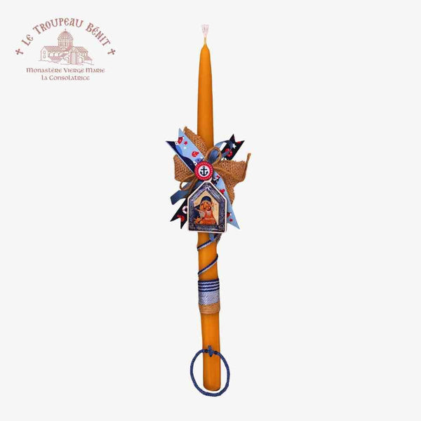 Decorative Paschal candle with artistic design on a white background with "Troupeau Benit" logo branding