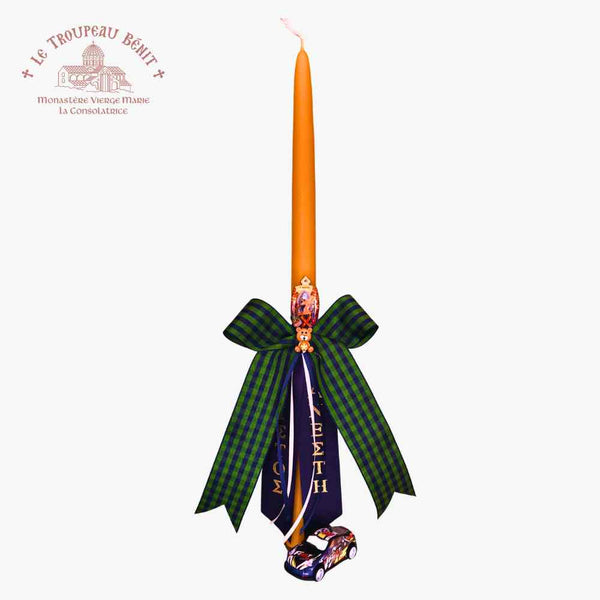 Decorative candle with a green bow and purple ribbon on a white background, featuring the Le Troupeau Benit logo.
