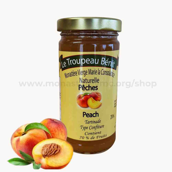 A jar of peach Jam with a label showing the brand 'Le Troupeau Beni', along with images of peaches.