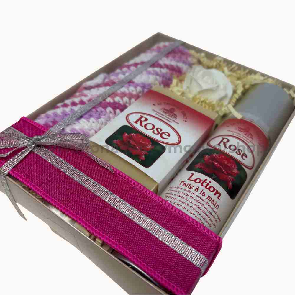 Gift set with 'Rose' branded products including lotion and hand cream in a decorative box.