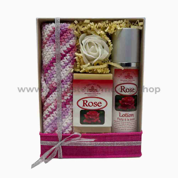 Gift set with a knitted wash cloth, goat milk soap, and lotion in a decorative box.