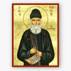 Icon of Saint Paisios the Athonite holding a cross and scroll on a gold background