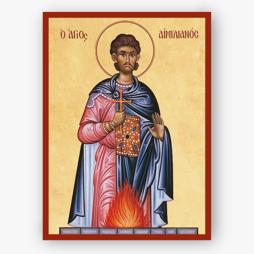 A religious icon print of Saint Aimilianos on a beige background with a red border, showing the saint in pink and blue robes holding a cross and book, with flames at the bottom.