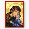 Saint Anna, holding the Theotokos who is holding a white flower on a gold background with a red border.