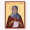 Icon of Saint Anthony of Egypt holding a scroll with text, framed by a red border.