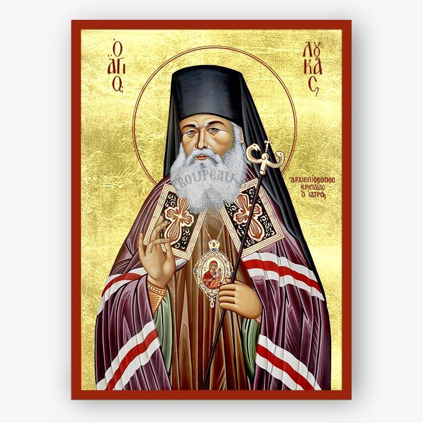 Icon of Saint Luke of Simferopol holding a staff and blessing, with decorative elements on a gold background.