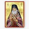 Icon of Saint Luke of Simferopol holding a staff and blessing, with decorative elements on a gold background.