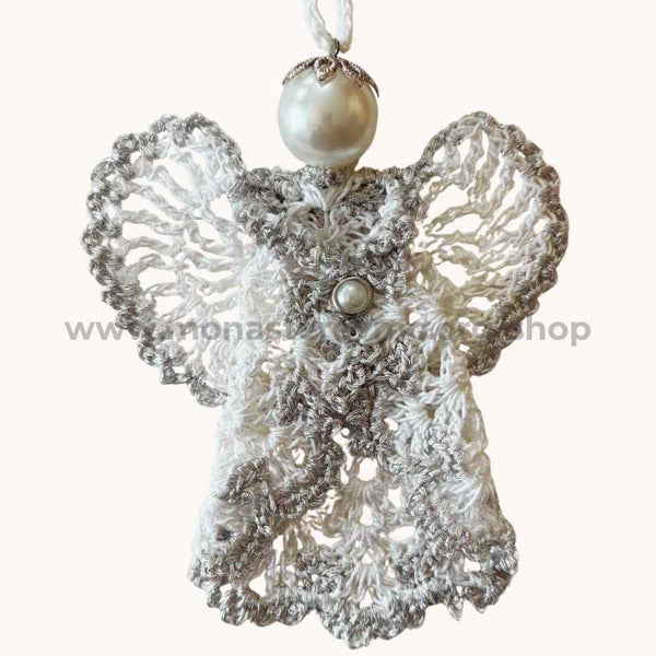 Decorative angel ornament with lace details and pearl accents on a white background