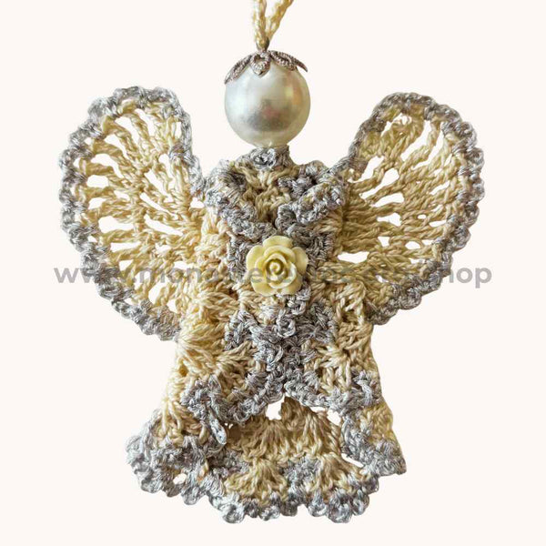 Decorative angel ornament with crocheted design, pearl, and rose detail on a white background.