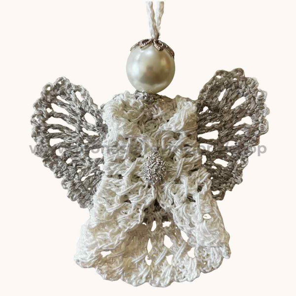 Decorative angel ornament with lace details and a pearl on a white background