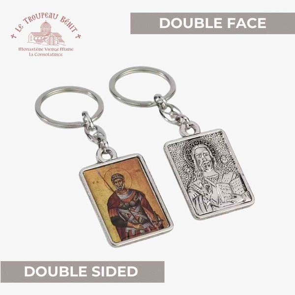 Double-sided keychain with religious imagery on a white background with 'Troupeau Benit' logo branding