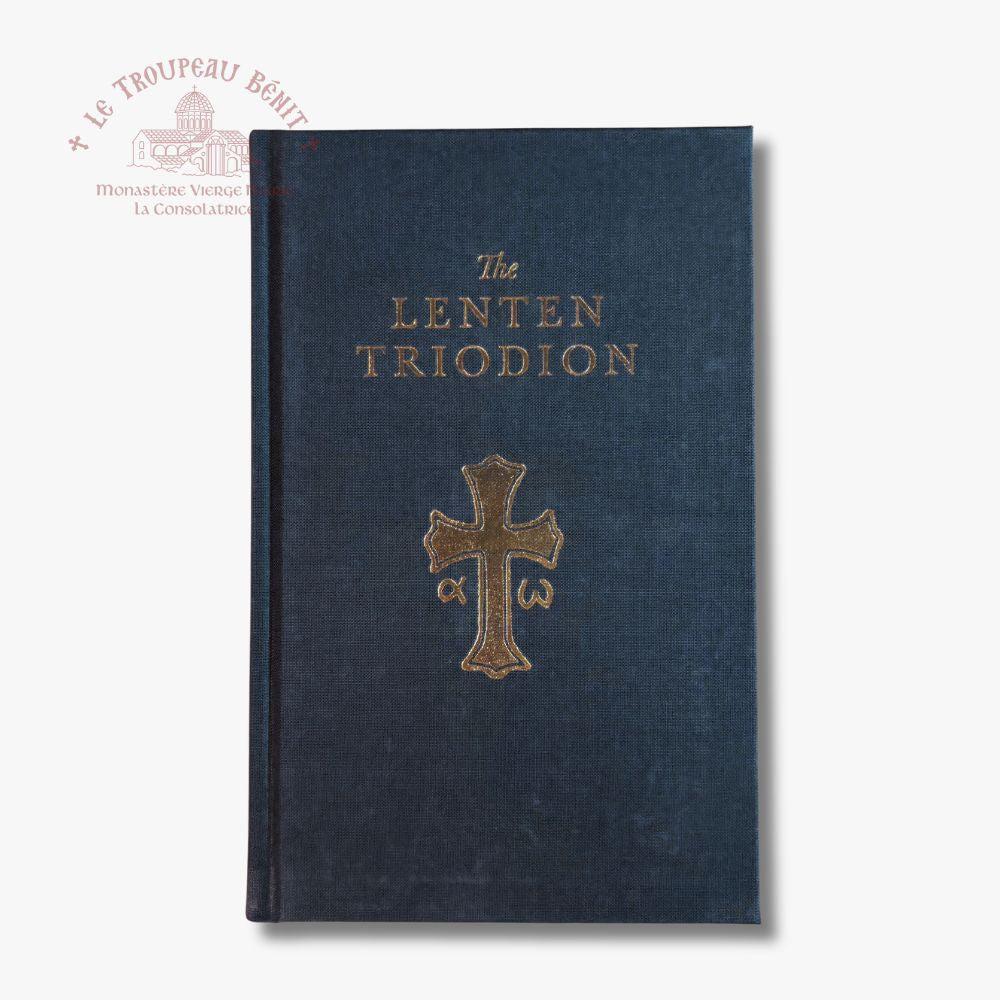 The Lenten Triodion book with a dark navy blue textured cover and gold lettering and cross emblem, shown on a light gray background with a Troupeau Benit watermark in the upper left.